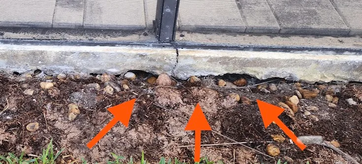 Visible void and soil loss beneath concrete slab in Spring Hill Florida