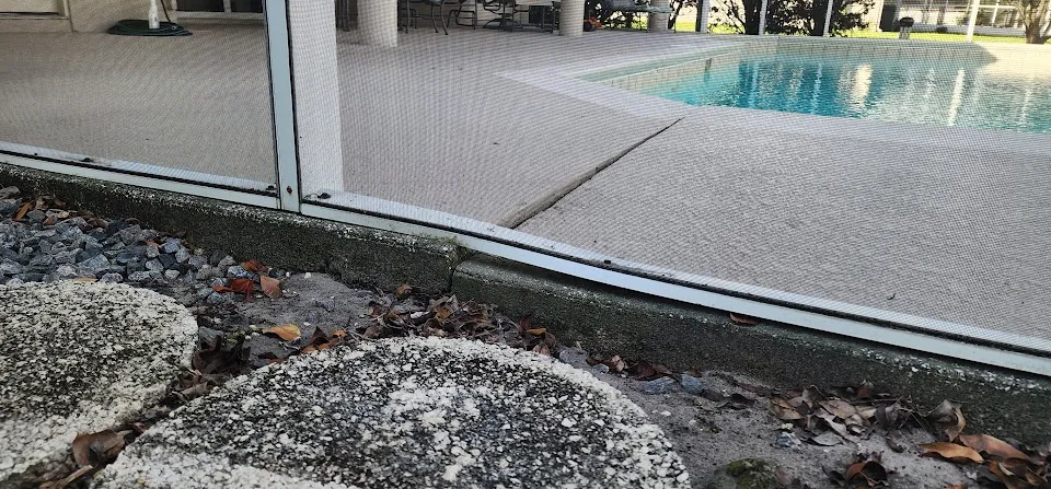 Settled pool deck concrete at screen enclosure in Southwest Florida