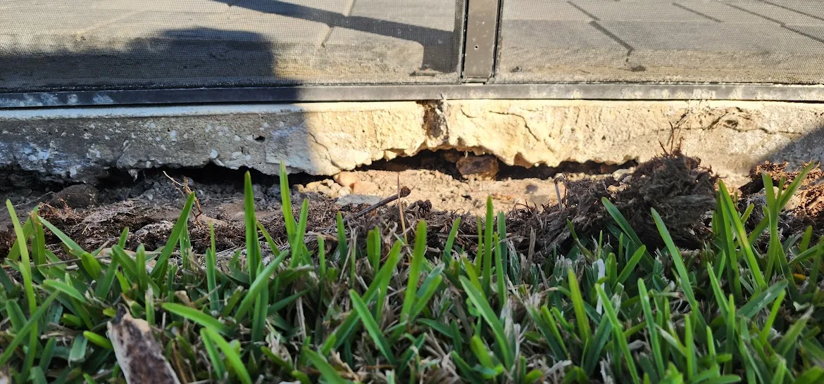 Empty space beneath a concrete slab where supporting soil has been lost