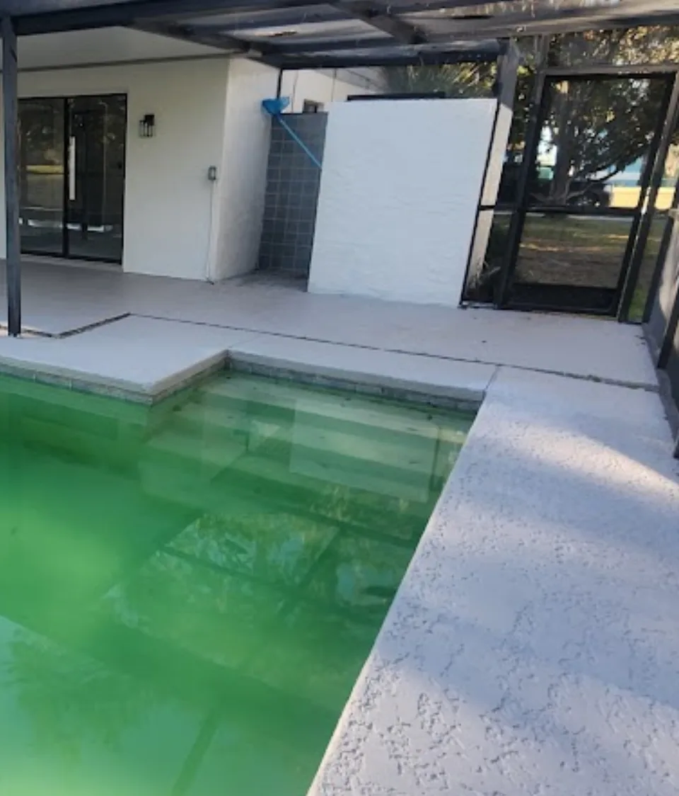 Settled concrete pool deck with uneven slabs around swimming pool