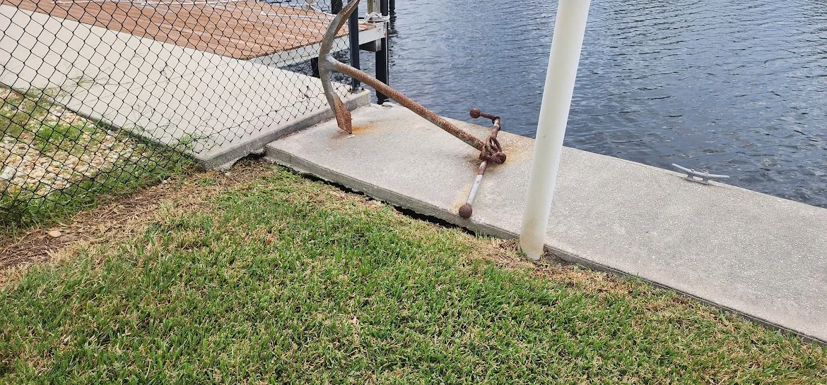 Loss of soil support beneath concrete beside a waterfront seawall in Southwest Florida