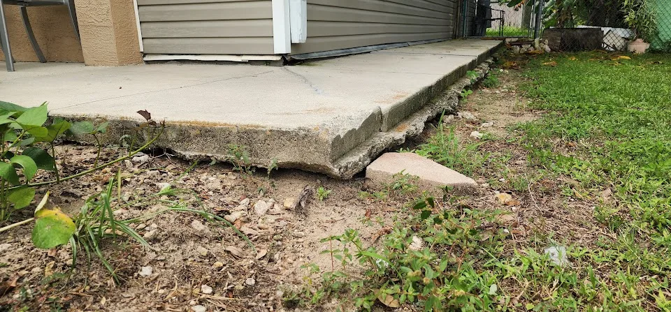 Soil erosion and washout beneath concrete causing loss of support